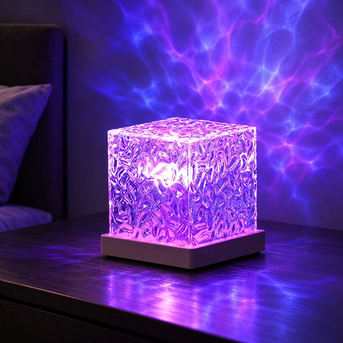 Faceted RGB ripple projector lamp on a dark table with violet-blue ambient glow